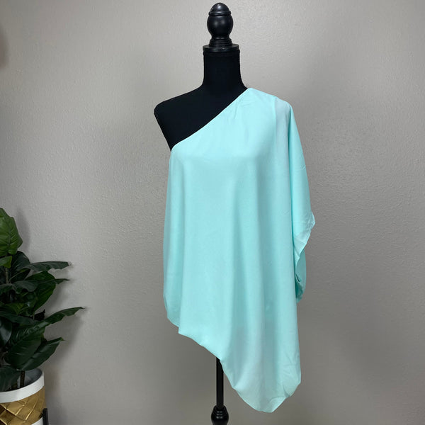 True to size. Bright turquoise in color. slants on sleeves and at waist. solid color. 